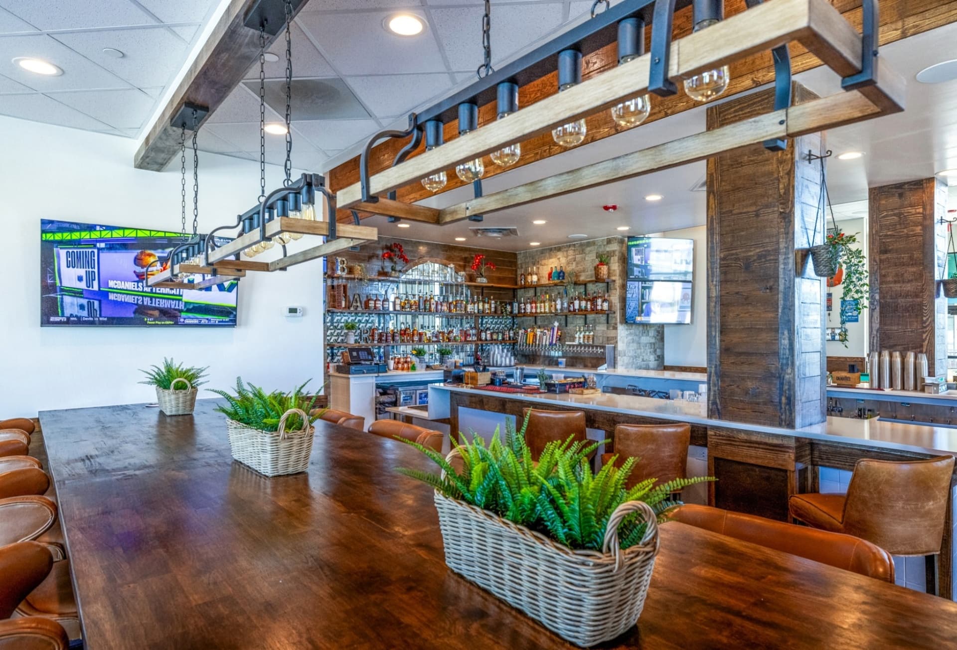 Barrel and Bones bar build-out with reclaimed wood and custom lighting