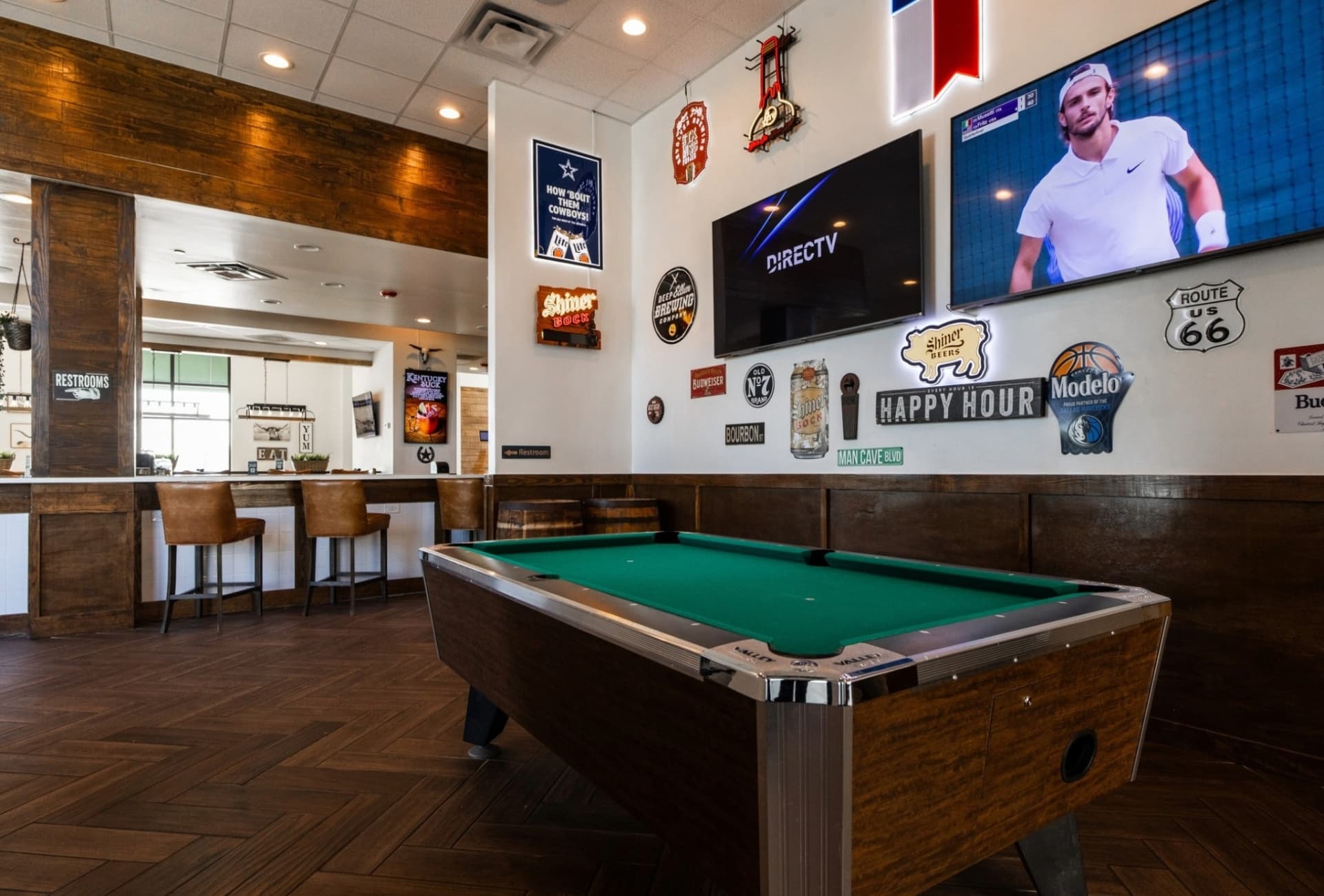 Sports bar with pool table and TV wall