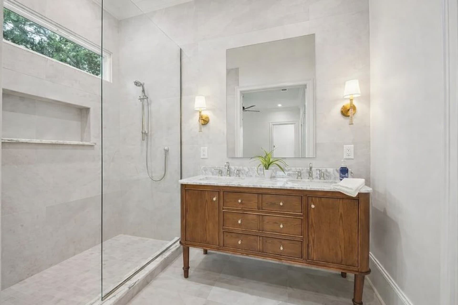 Bluff View Dallas bathroom remodel wood vanity with marble countertop