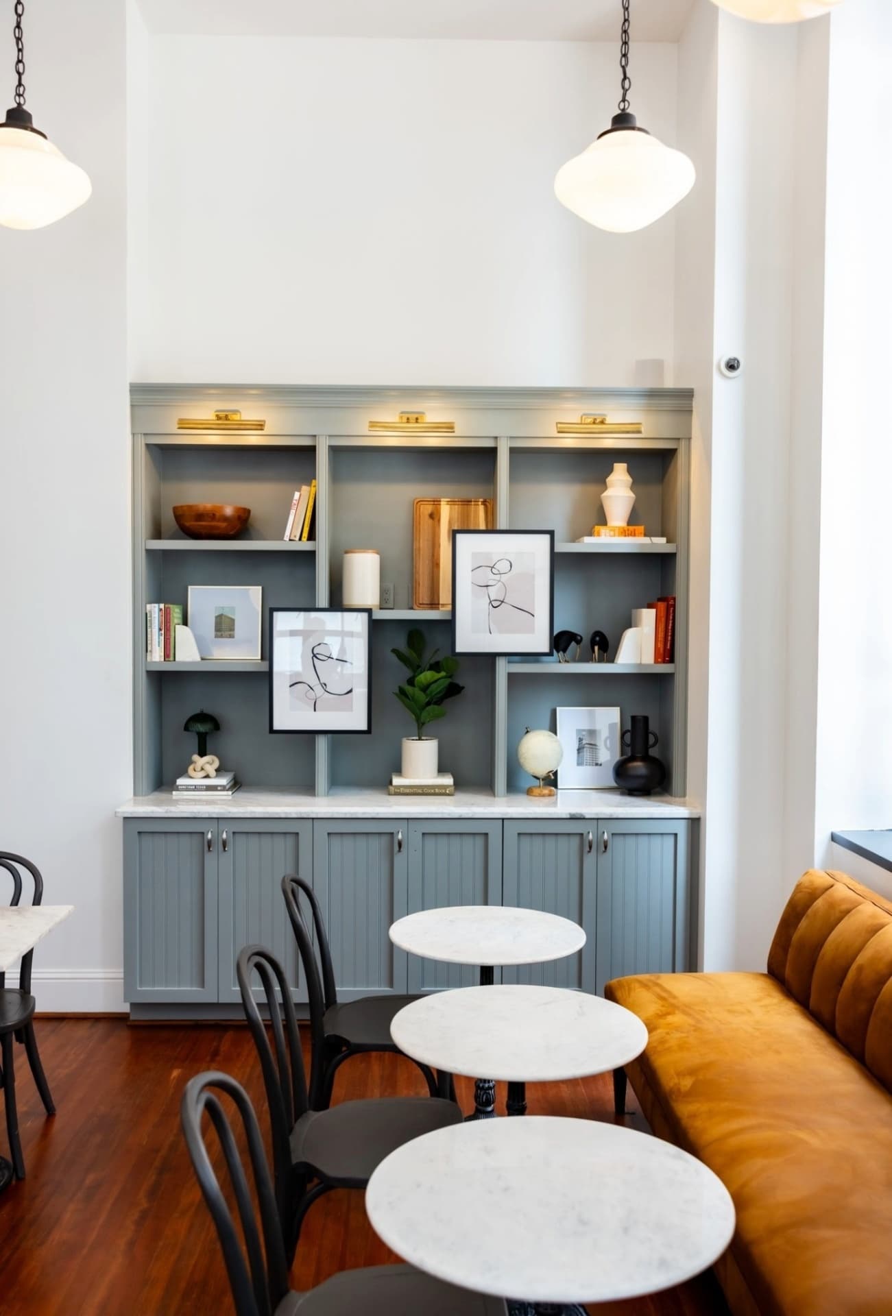 Boxed and Brewed banquette seating with built-in shelving display