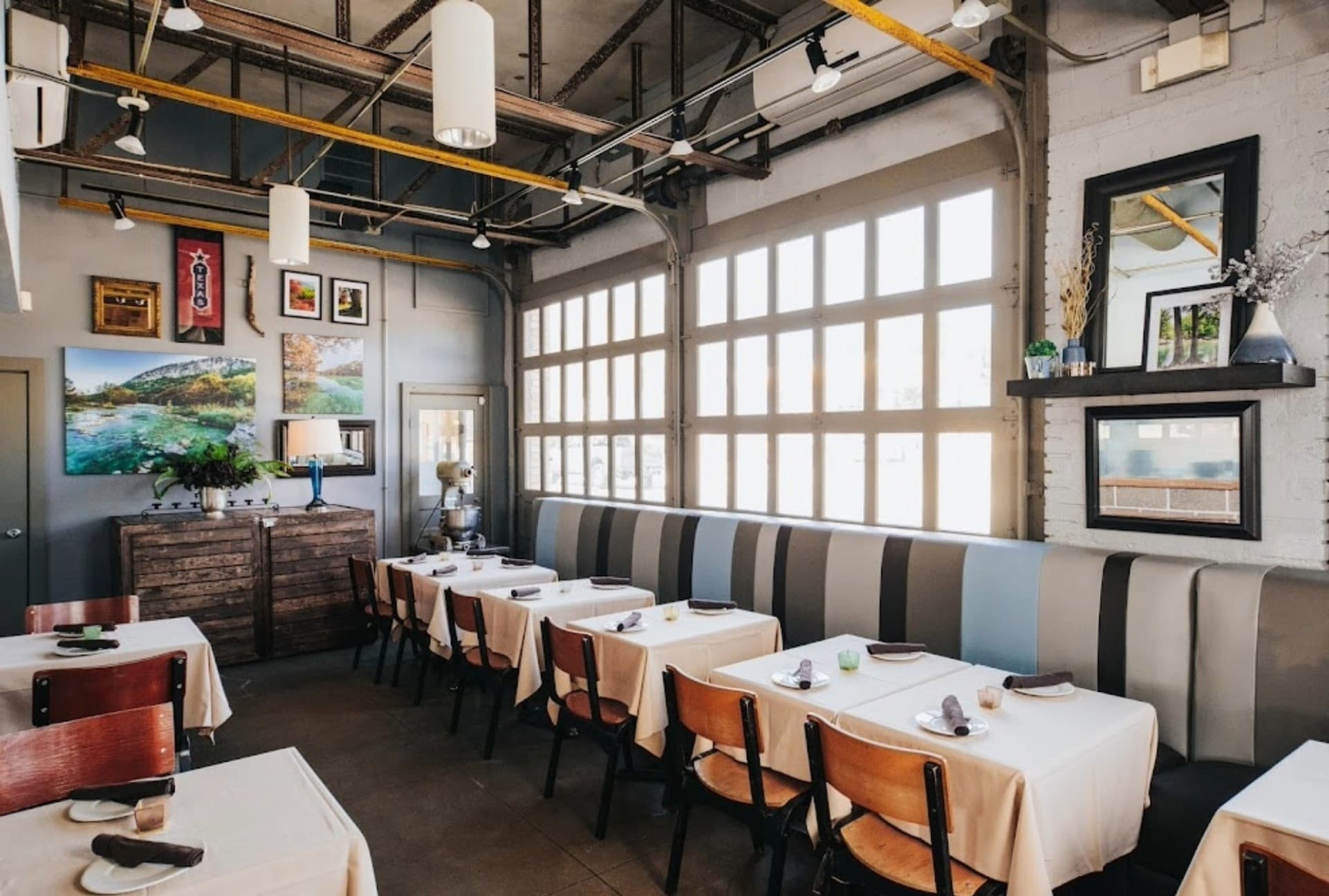 Encina restaurant dining room booth seating with garage door windows