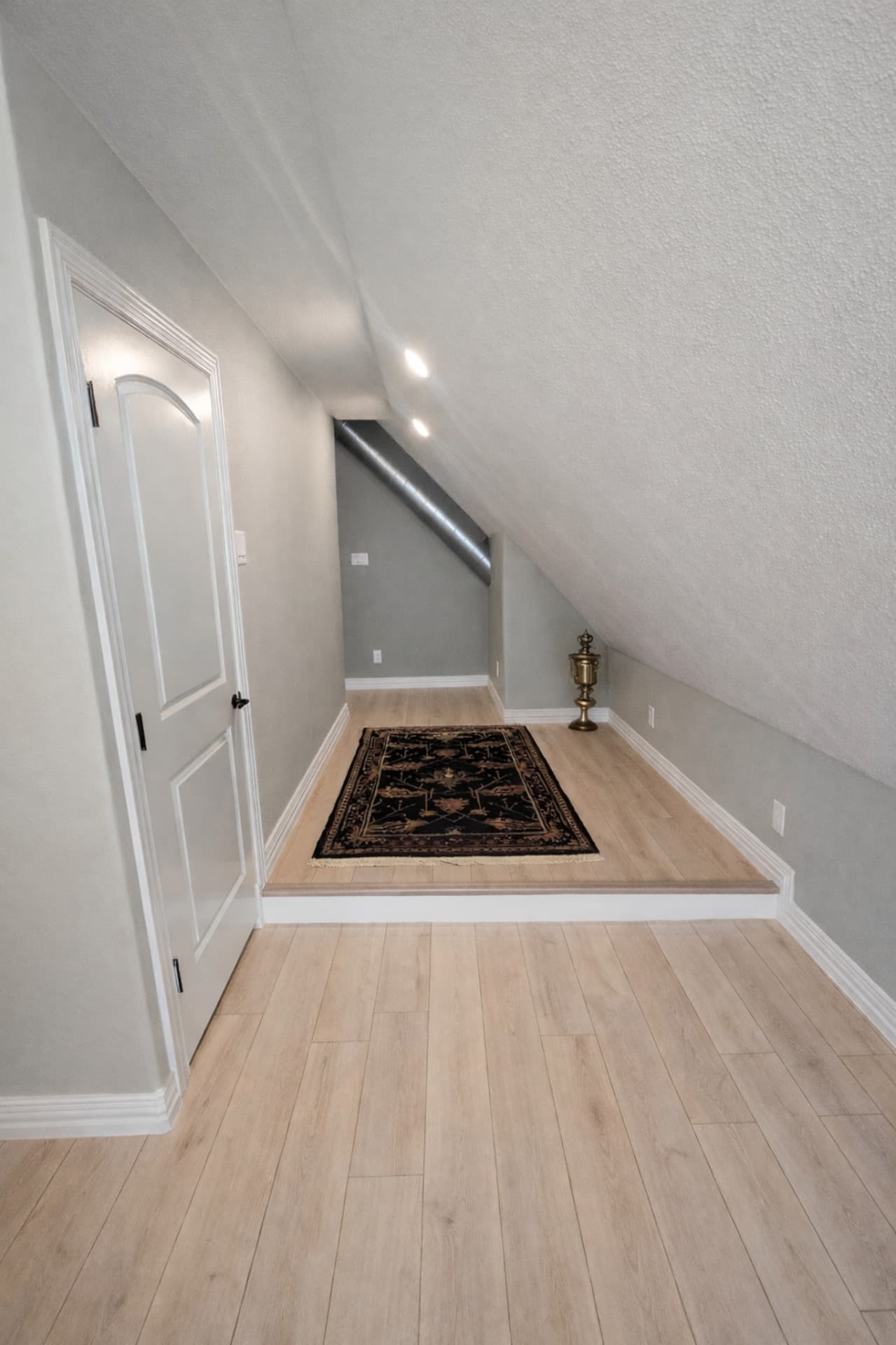 Grapevine TX attic conversion living space with chandelier and skylights