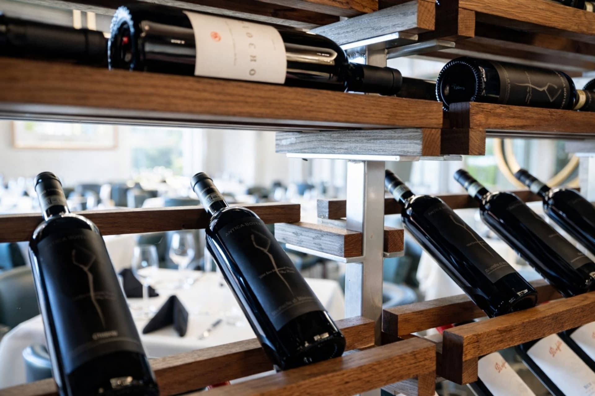 LVI Steak House wine rack detail with dining room view Statler Hotel