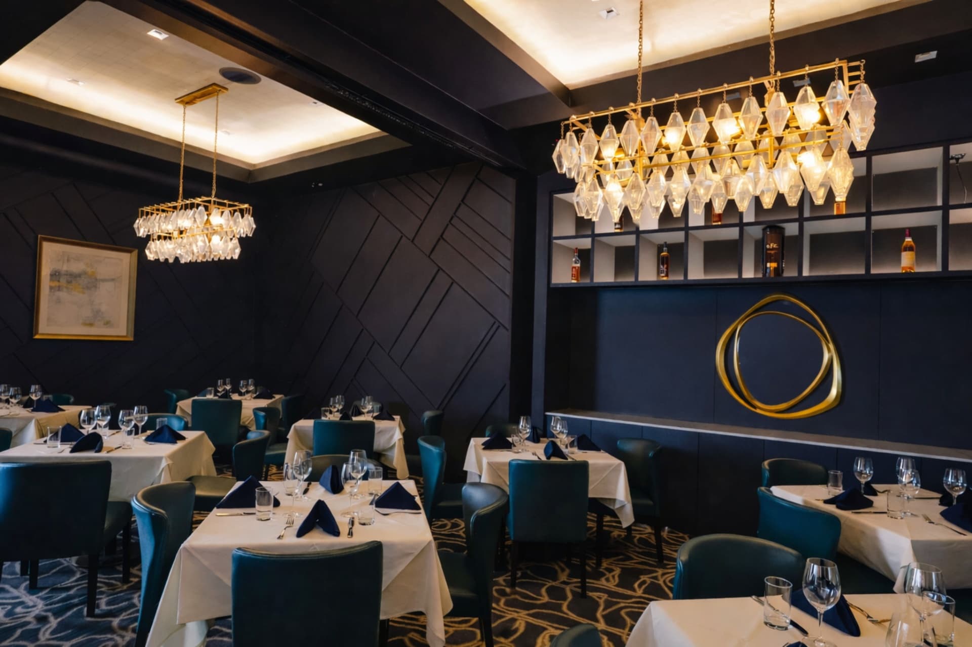 LVI Steak House private dining room with crystal chandeliers and accent wall