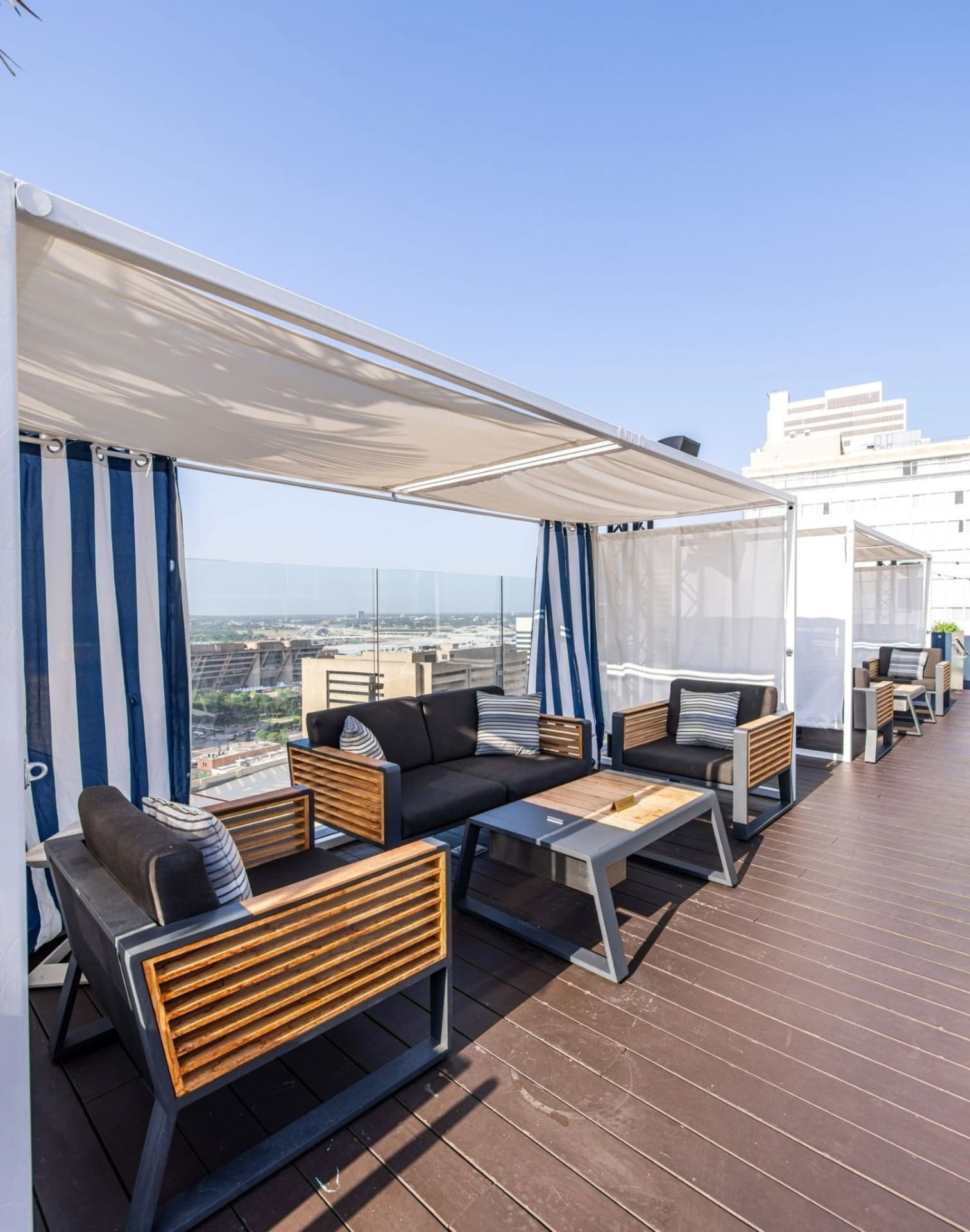Waterproof rooftop cabana lounge seating with city views Statler Hotel