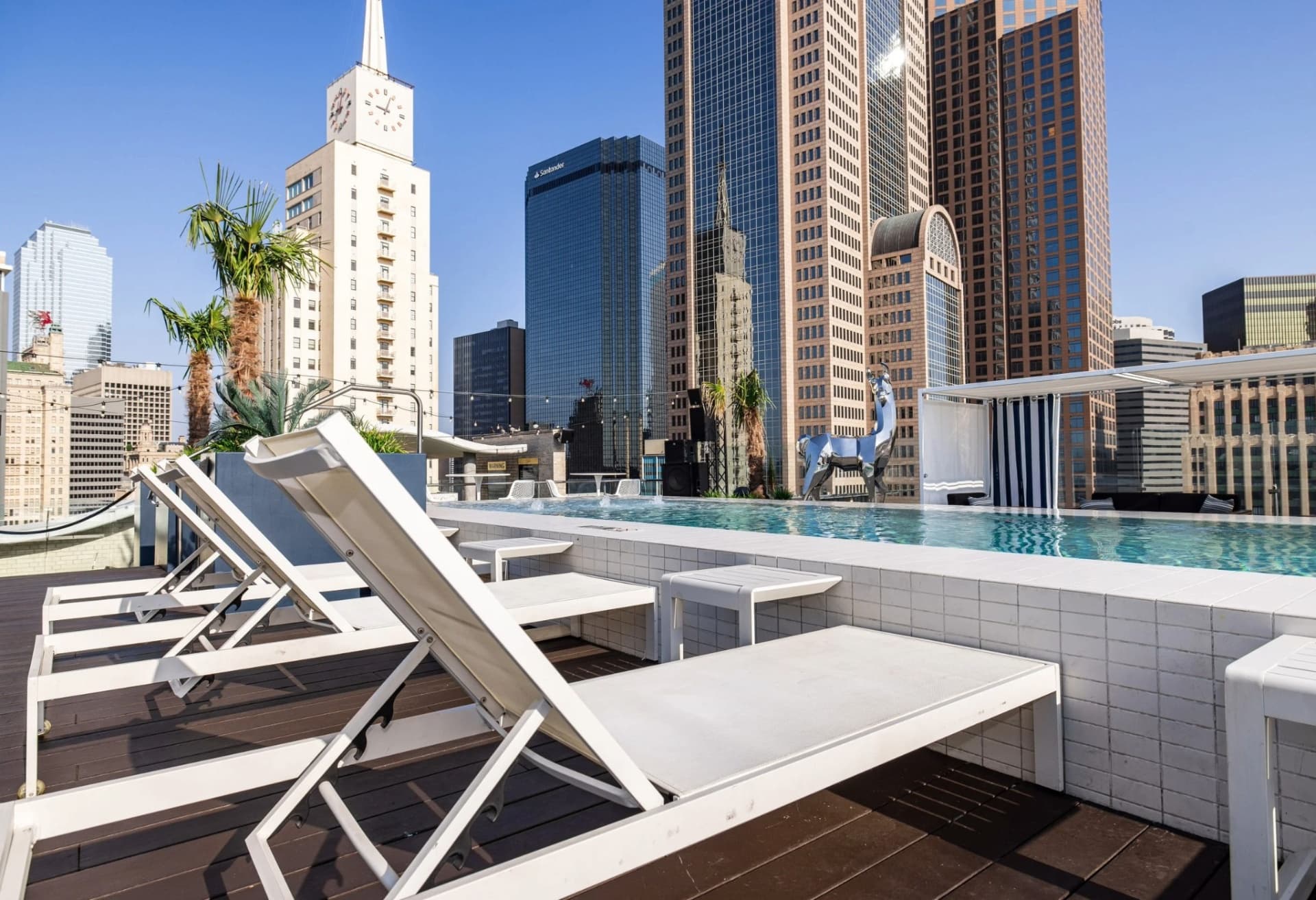 Waterproof rooftop pool deck with lounge chairs and skyline view Dallas TX
